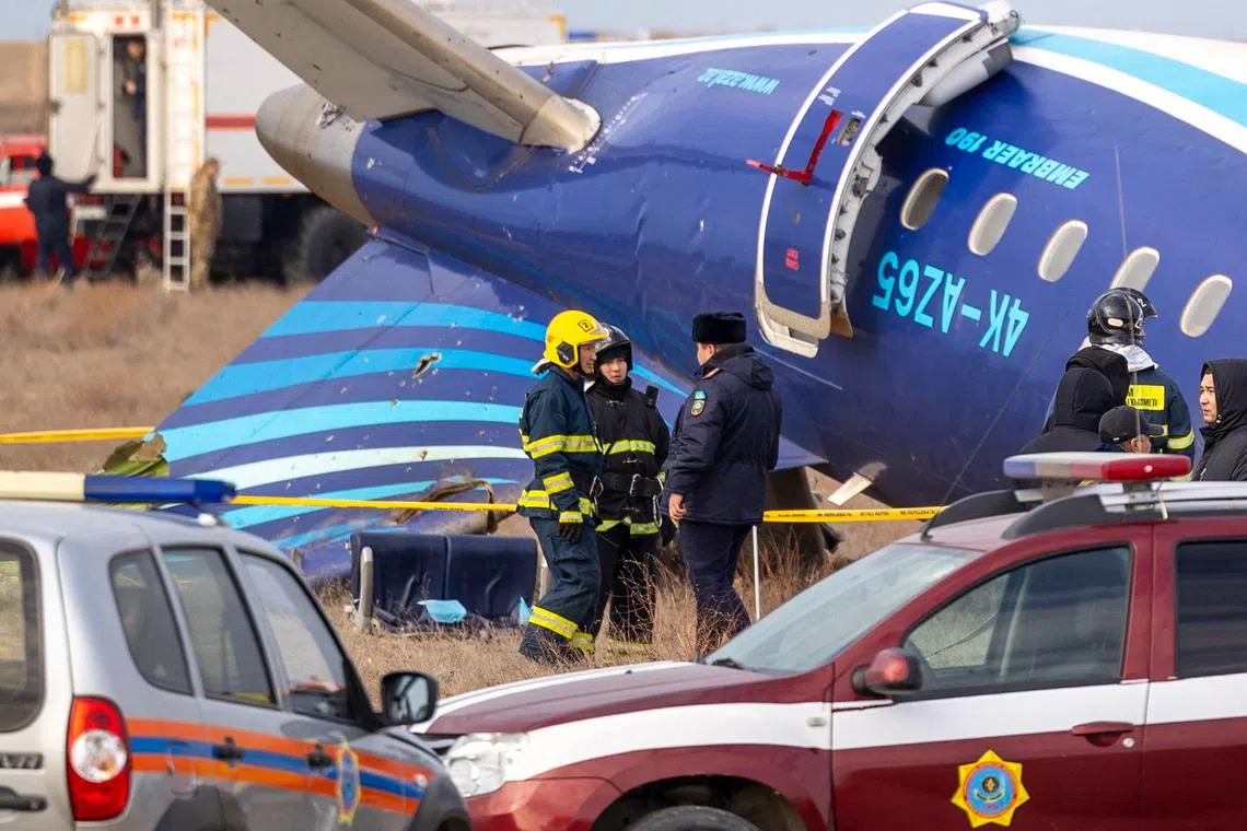 Emergency specialists working at the crash site, near the western Kazakh city of Aktau, on Dec 25.