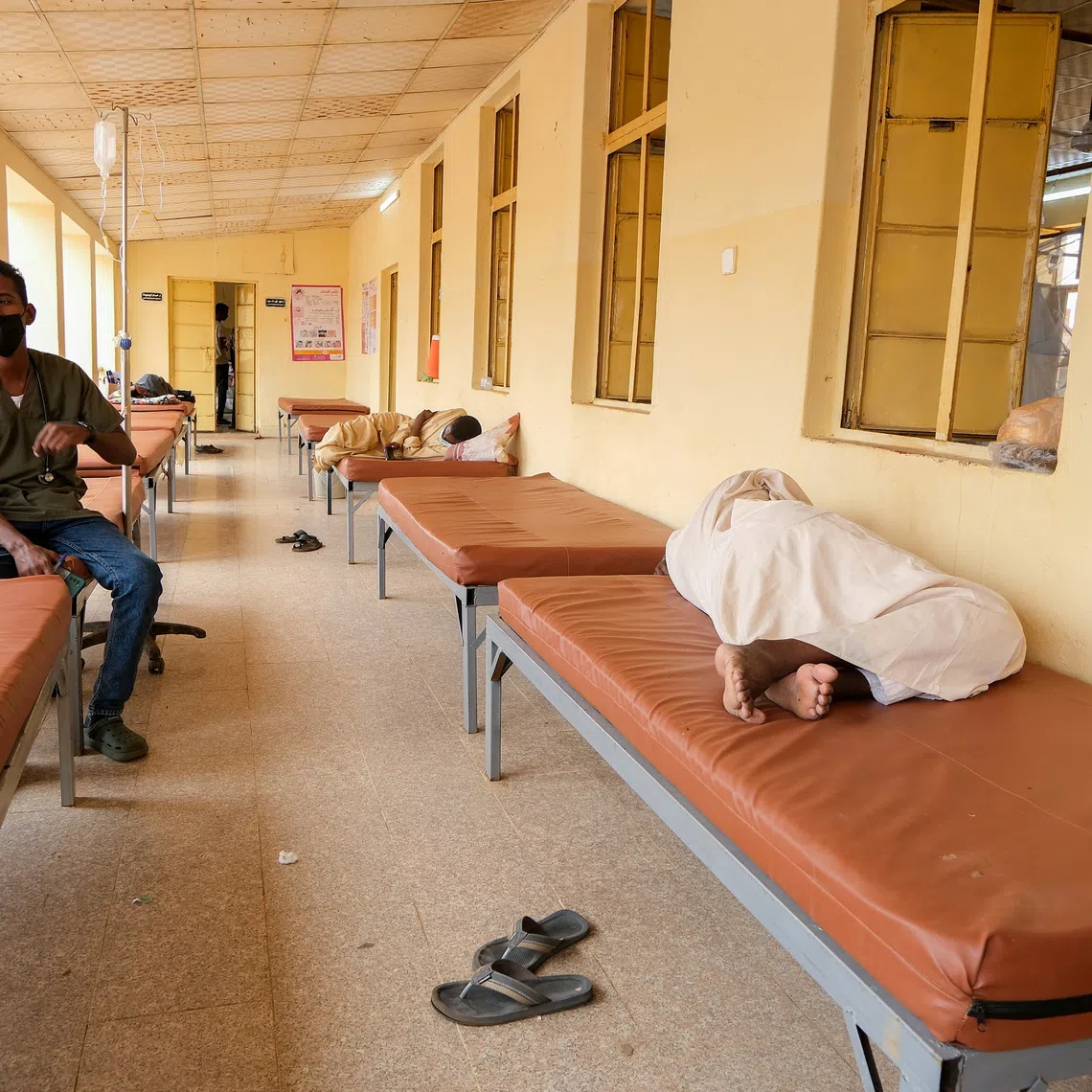 A Sudanese doctor sits on a bed while monitoring dengue fever patients at Omdurman Hospital, as Sudan grapples with outbreaks of dengue and cholera amid the annual rainy season and a collapsed healthcare and infrastructure system, in Khartoum, Sudan, September 23, 2025. REUTERS/El Tayeb Siddig
