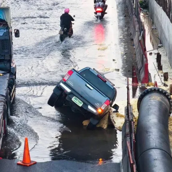 A pickup truck plunged into a sinkhole created by a sudden road collapse on the parallel lane of Rama II Road on Jan 17, 2026.