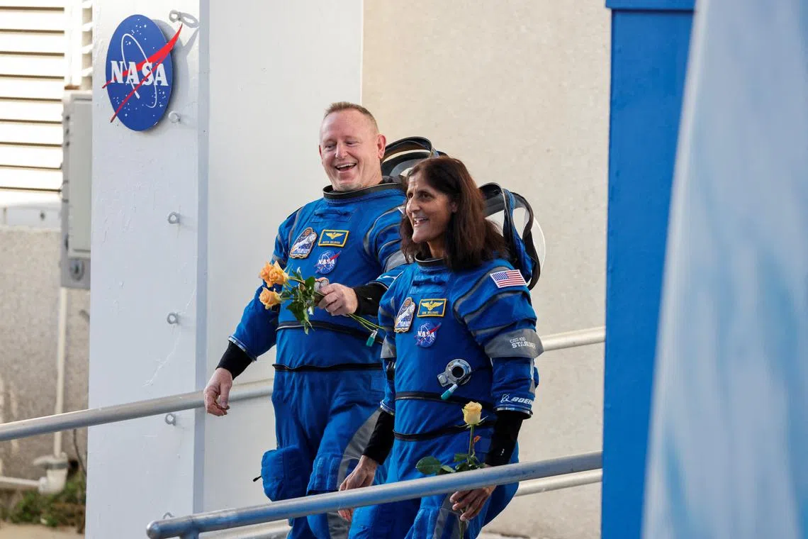 FILE PHOTO: NASA astronauts Butch Wilmore and Suni Williams walk at NASA's Kennedy Space Center, ahead of Boeing's Starliner-1 Crew Flight Test (CFT) mission on a United Launch Alliance Atlas V rocket to the International Space Station, in Cape Canaveral, Florida, U.S., June 5, 2024. REUTERS/Joe Skipper/File Photo