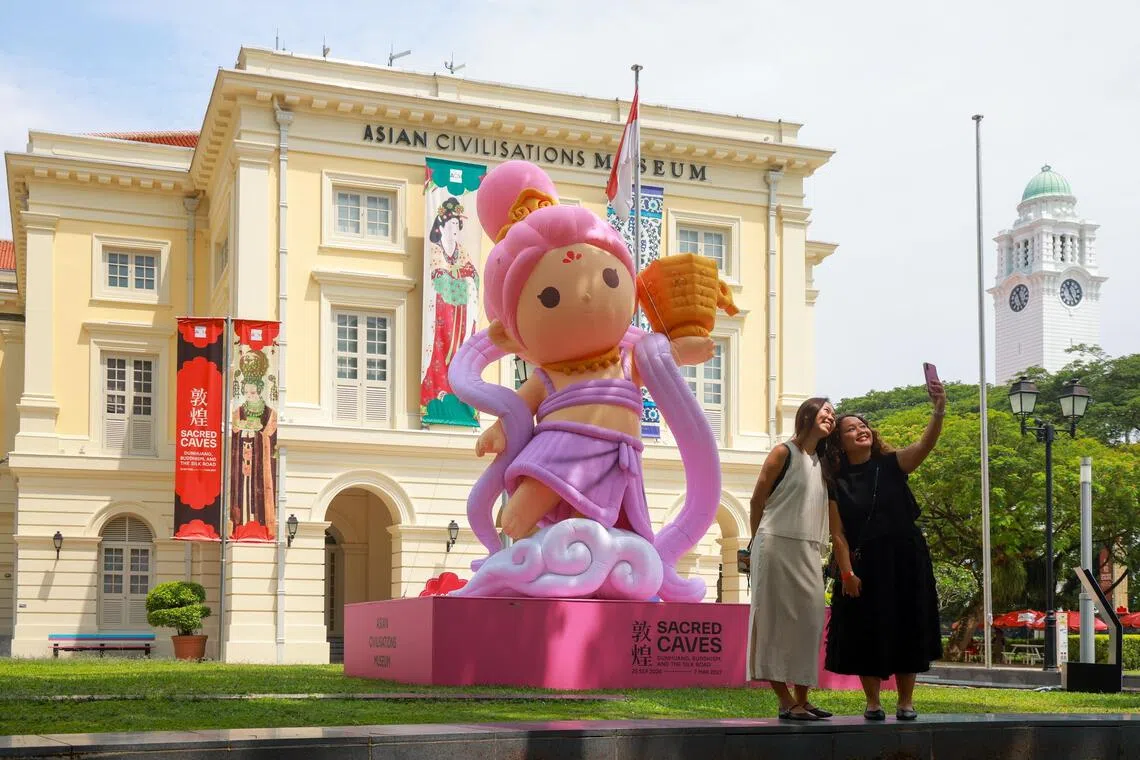 An inflatable apsara stands tall on Empress Lawn in front of the ACM.
