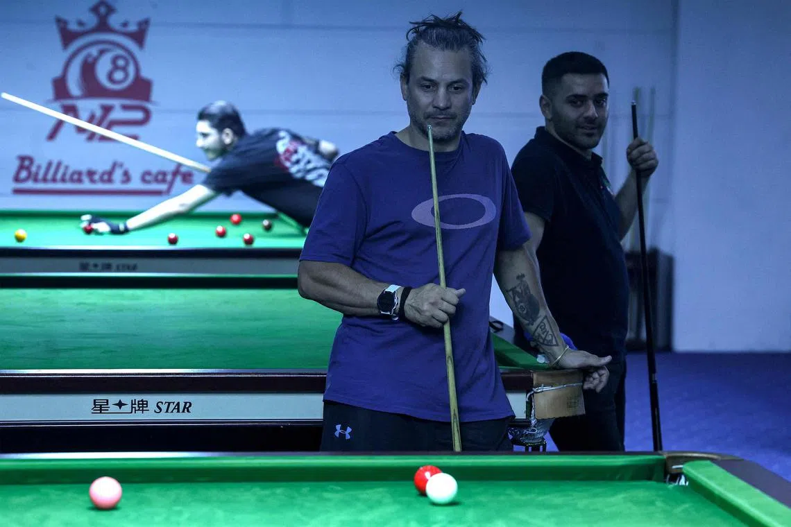 A man playing snooker at a club in Teheran on June 26. A passion for snooker has swept Iran in recent years, a trend fans attribute largely to the country's first internationally renowned star Hossein Vafaei, known as the "Persian Prince".