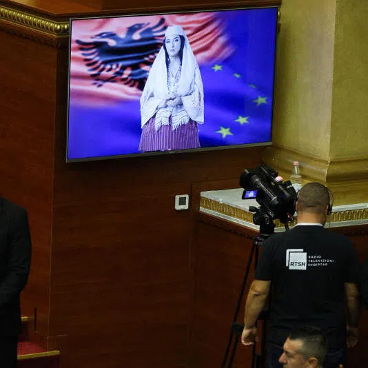 Albania's AI-generated minister "Diella"  insisting its role is to help people not replace them, during its first appearance in Parliament in September. 