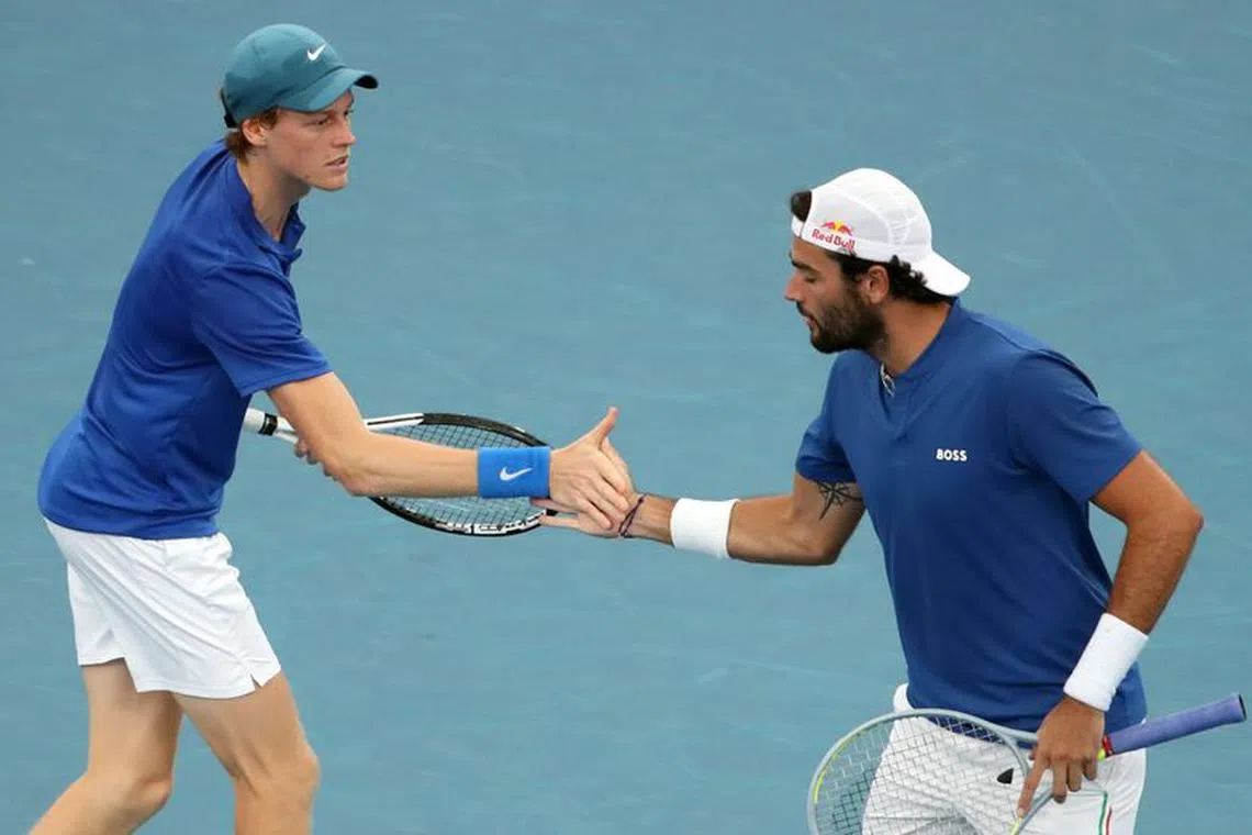 FILE PHOTO: Tennis - ATP Cup - Sydney Olympic Park, Sydney, Australia - January 6, 2022  Italy's Matteo Berrettini and Jannik Sinner react during their group stage doubles match against Russia's Daniil Medvedev and Roman Safiullin REUTERS/Asanka Brendon Ratnayake