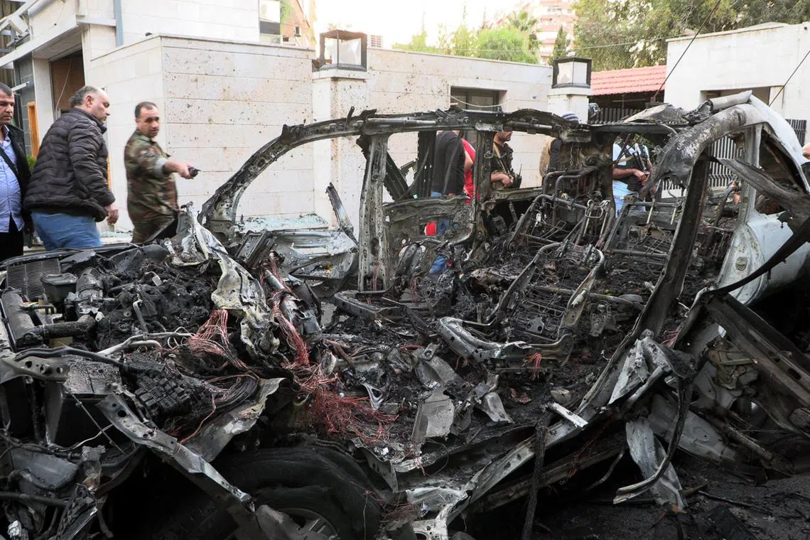 Syrian soldiers inspecting the site of an airstrike that targeted a vehicle in the Al-Mazzeh neighborhood in Damascus, Syria, on Oct 21. At least two people were killed according to Syrian state news agency, quoting military sources.  