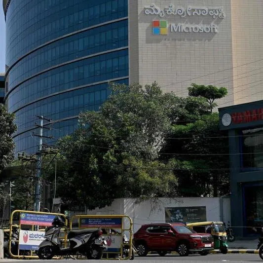 Commuters drive past the Microsoft office in Bengaluru on Dec 10. The company has promised $22 billion investment in India's AI infrastructure. 