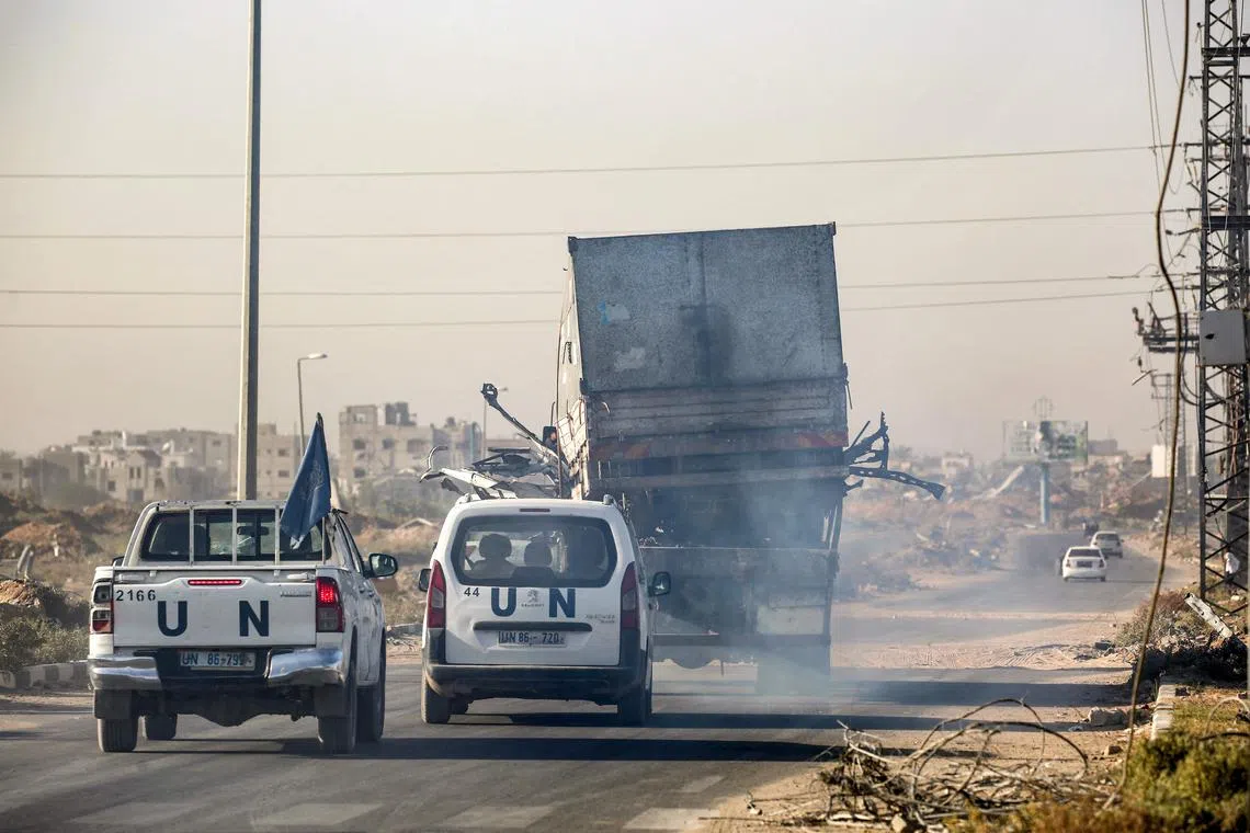 UN vehicles escort a trailer carrying a destroyed truck that was reportedly used by UNRWA workers, after it was fired upon by Israeli forces in the Gaza Strip, on Oct 23.