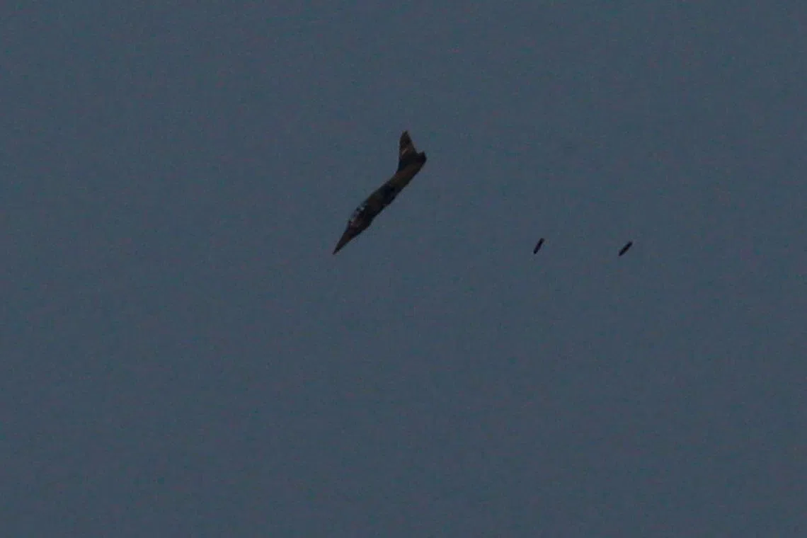 FILE PHOTO: A warplane carries out a bombing run above Syria near the Israeli-Syrian border as it is seen from the Israeli-occupied Golan Heights , Israel July 24, 2018. REUTERS/Ammar Awad/File Photo
