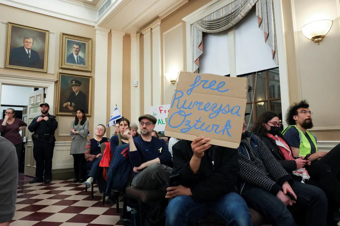 FILE PHOTO: Demonstrators attend a city council meeting after Tufts PhD student Rumeysa Ozturk was taken into custody by federal agents, in Somerville, Massachusetts, U.S. March 27, 2025.  REUTERS/Reba Saldanha/File Photo