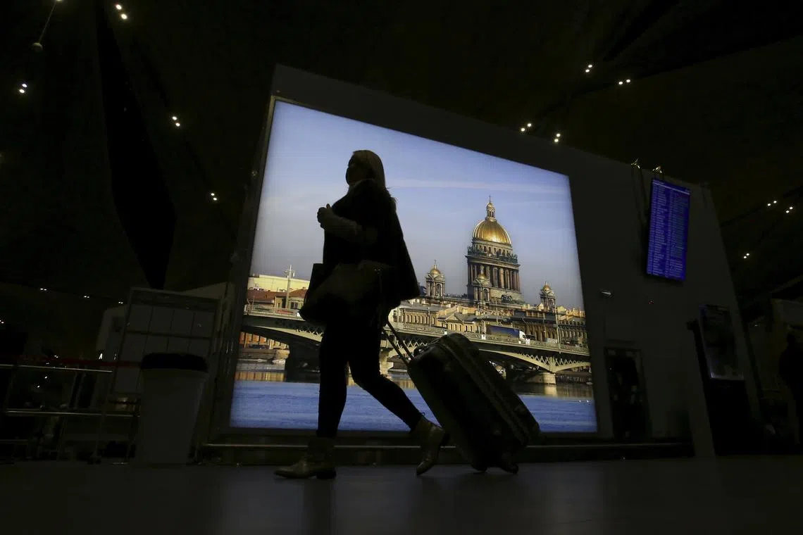 FILE PHOTO: A passenger with luggage walks at Pulkovo airport outside St. Petersburg, Russia, November 7, 2015. REUTERS/Peter Kovalev/File Photo