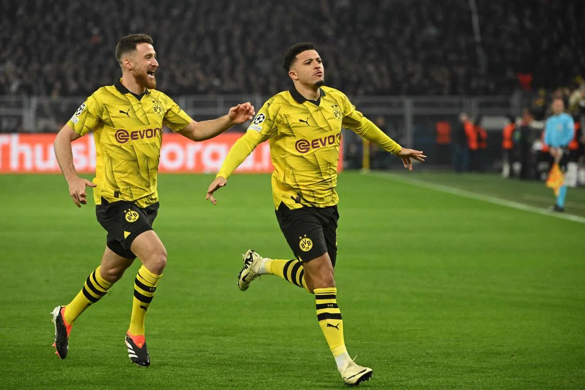 Dortmund's Jadon Sancho (right) celebratng after scoring the opening goal in their Champions League game against PSV Eindhoven.