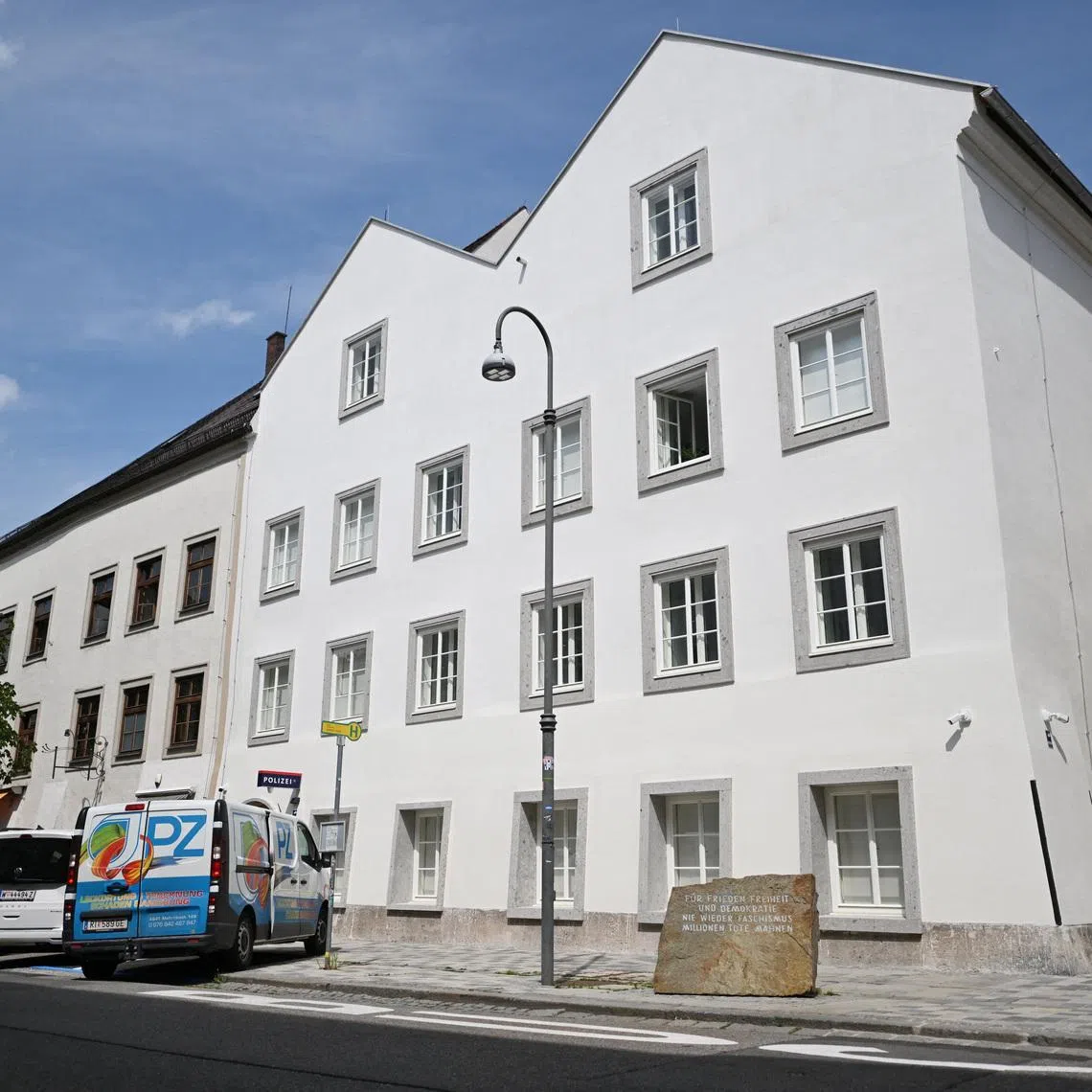 Vehicles are parked outside the building where Adolf Hitler was born, which has been converted into a police station by Austria's government in hopes of preventing it from serving as a place of ‌pilgrimage for neo-Nazis, in Braunau am Inn, Austria, July 16, 2026. REUTERS/Angelika Warmuth