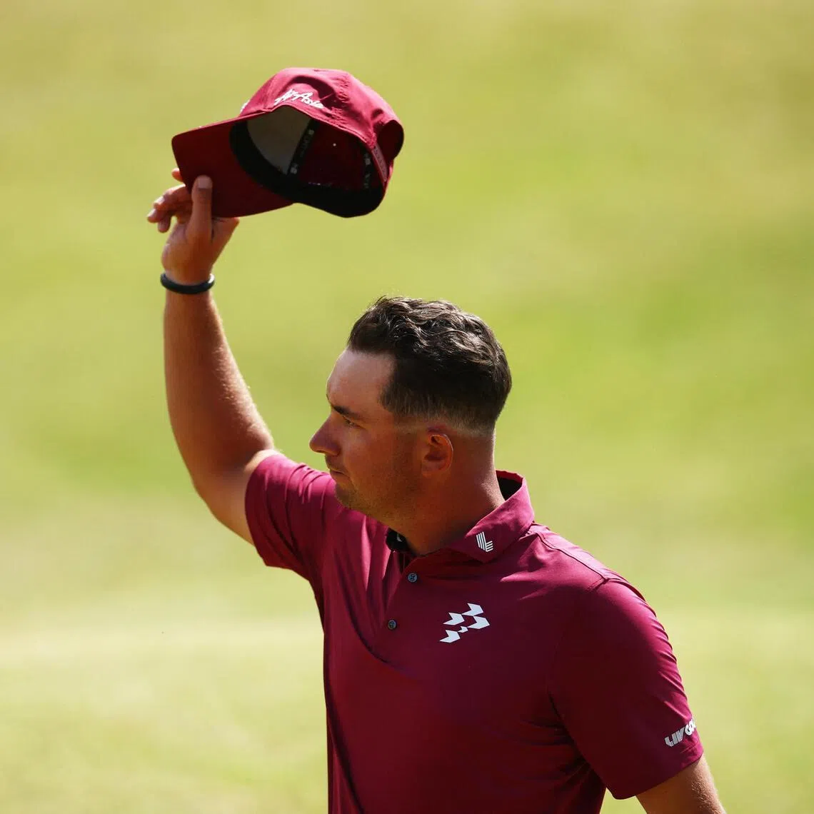 Australia’s Lucas Herbert acknowledges spectators after making his putt for bogey on the 18th hole during the second round of the British Open.