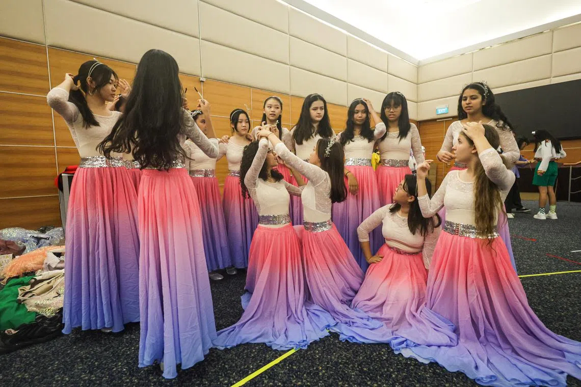 The young ChildAid performers playing characters called The Dream Girls, whose ages range from 10 to 16, trying out their colourful costumes for first time at the SPH News Centre Auditorium.