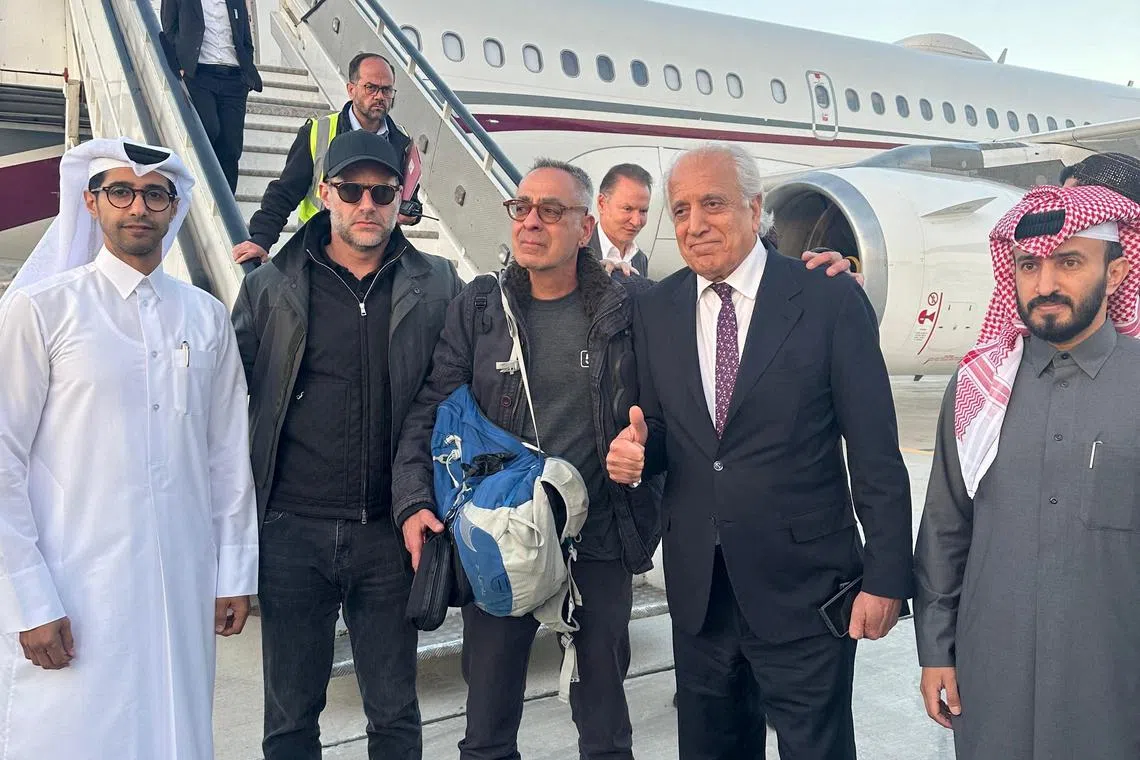 U.S. citizen George Glezmann stands at Kabul airport, following his release from Afghan custody, with U.S. hostage envoy Adam Boehler, former U.S. special representative for Afghanistan Reconciliation Zalmay Khalilzad and Qatari diplomats, before departing for Doha, Qatar, in Kabul, Afghanistan March 20, 2025. Qatar's Ministry of Foreign Affairs/Handout via REUTERS