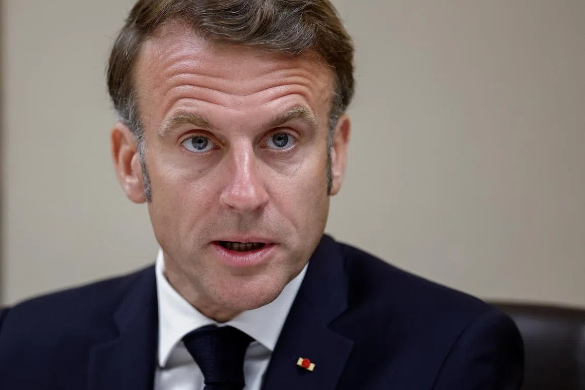 FILE PHOTO: French President Emmanuel Macron flanked by French Presidency General Secretary Emmanuel Moulin and France's General Fabien Mandon attends a national security meeting on the crisis between Israel and Iran in the Jupiter room at the Elysee Palace in Paris, France, June 22, 2025. REUTERS/Benoit Tessier/Pool/ File Photo