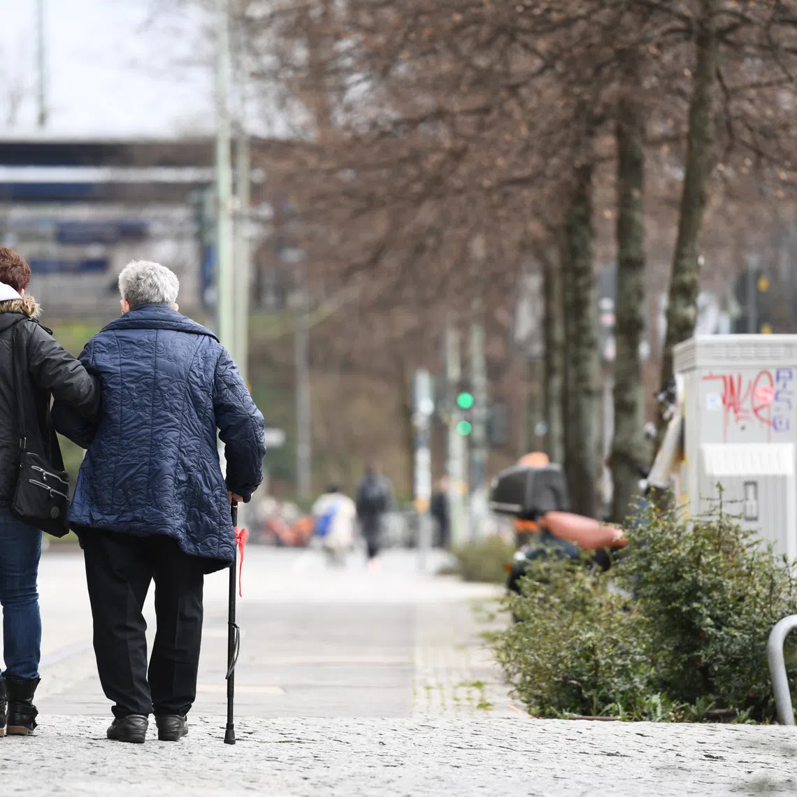 Two elderly persons walk in Berlin, Germany, March 19, 2020. REUTERS/Annegret Hilse
