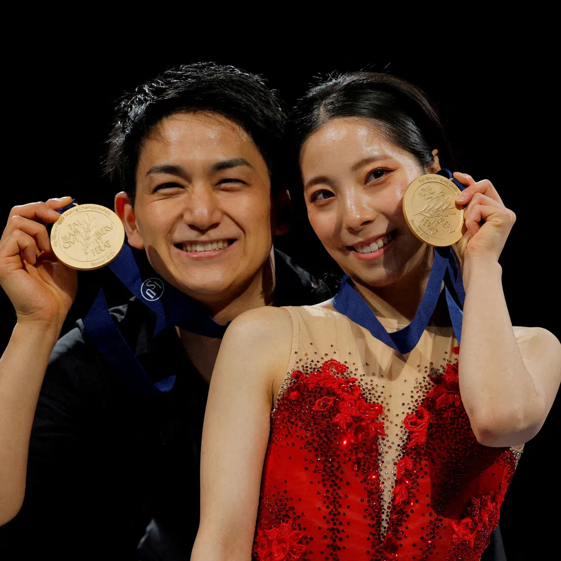 FILE PHOTO: Figure Skating - ISU World Championships - TD Garden, Boston, Massachusetts, U.S. - March 27, 2025  Gold medallists Japan's Riku Miura and Ryuichi Kihara celebrate after winning the pairs REUTERS/Brian Snyder/File Photo