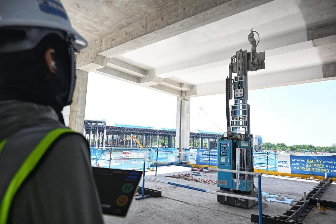 A robot carrying out painting works at the Changi East Depot construction site on May 20. It can reach heights of up to 6m.