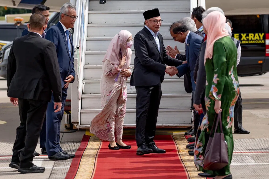 Malaysia PM Anwar Ibrahim and his wife Dr Wan Azizah Wan Ismail arrive at the Soekarno-Hatta International Airport in Jakarta on Sunday.