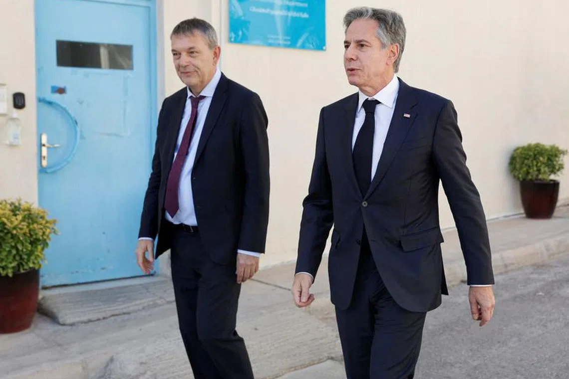 U.S. Secretary of State Antony Blinken walks with UN Relief and Works Agency for Palestine Refugees in the Near East (UNRWA) Commissioner-General Philippe Lazzarini, during a day of meetings about the ongoing conflict between Israel and the Palestinian Islamist group Hamas, in Amman, Jordan, November 4, 2023. REUTERS/Jonathan Ernst/Pool