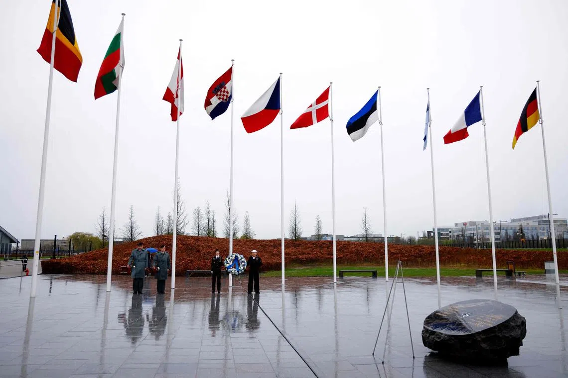 Nato members of the armed forces waiting for the start of the wreath laying ceremony marking Nato's 75th anniversary at the Flag Circle outside Nato Headquarters in Brussels on April 4.