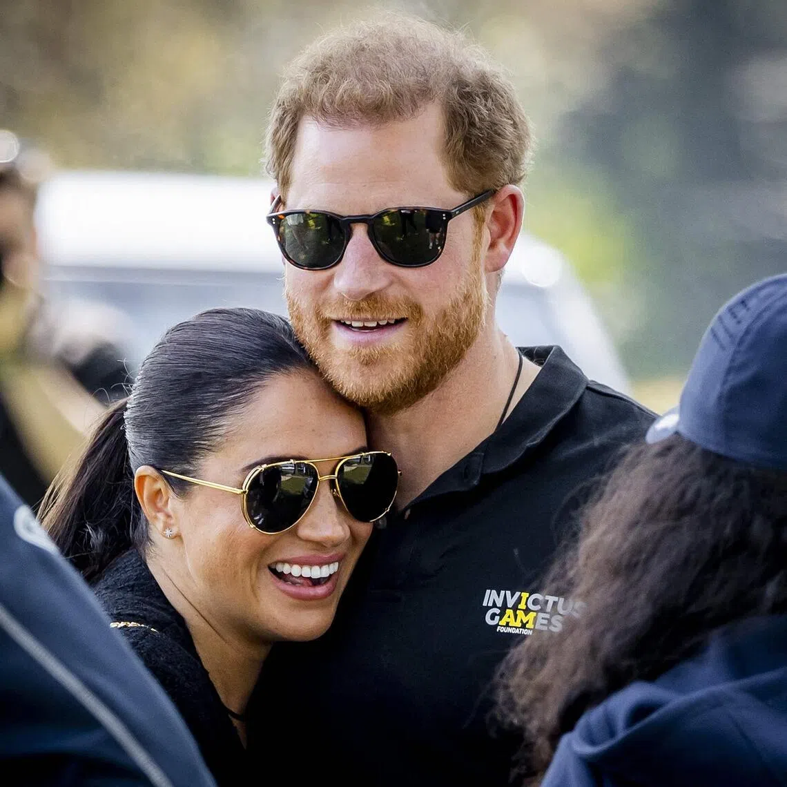 Britain’s Prince Harry and his wife Meghan Markle embrace at The Invictus Games in The Hague on April 16, 2022.