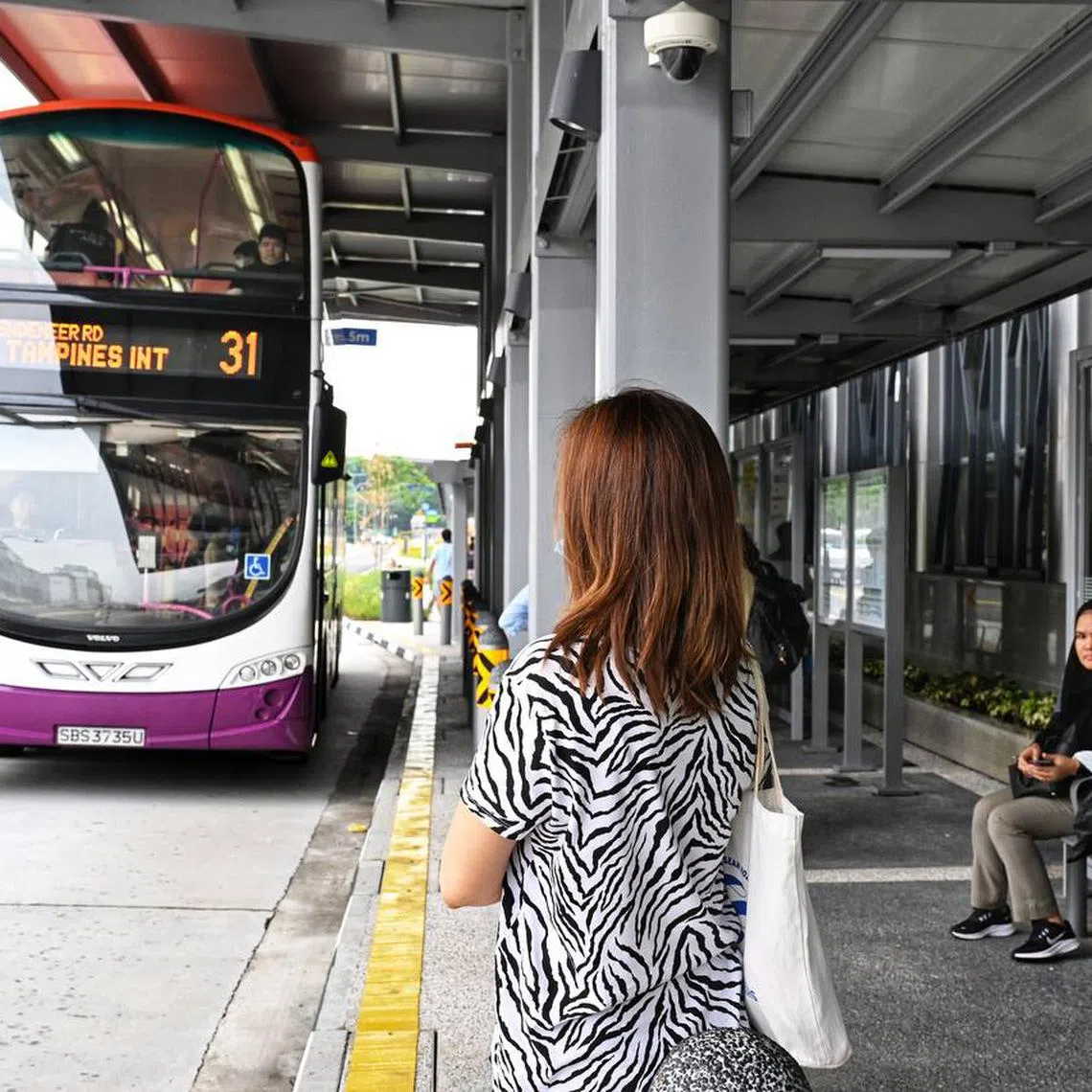 The pillars at the bus stop are making it more difficult to see approaching buses.