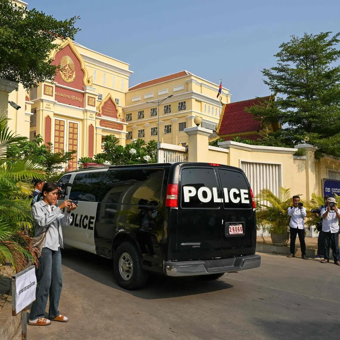 A police car transports Kem Sokha, former opposition leader of the Cambodia National Rescue Party, into the Appeal Court for a verdict against his treason conviction.