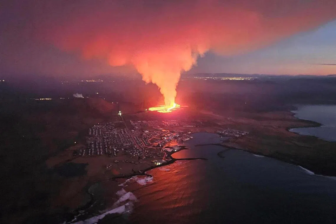 A volcano spews lava and smoke as it erupts in Reykjanes peninsula, Iceland.
