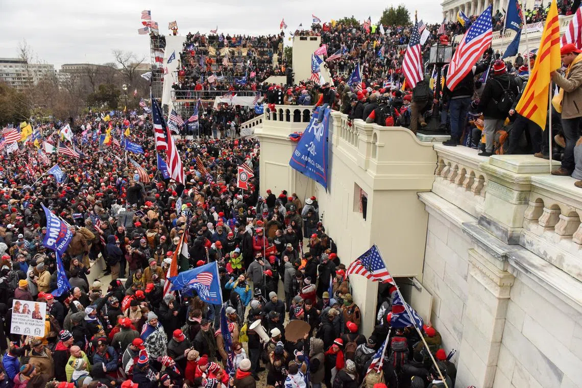 FILE PHOTO: Supporters of U.S. President Donald Trump gather in front of the U.S. Capitol Building in Washington, U.S. January 6, 2021. REUTERS/Stephanie Keith/File Photo
