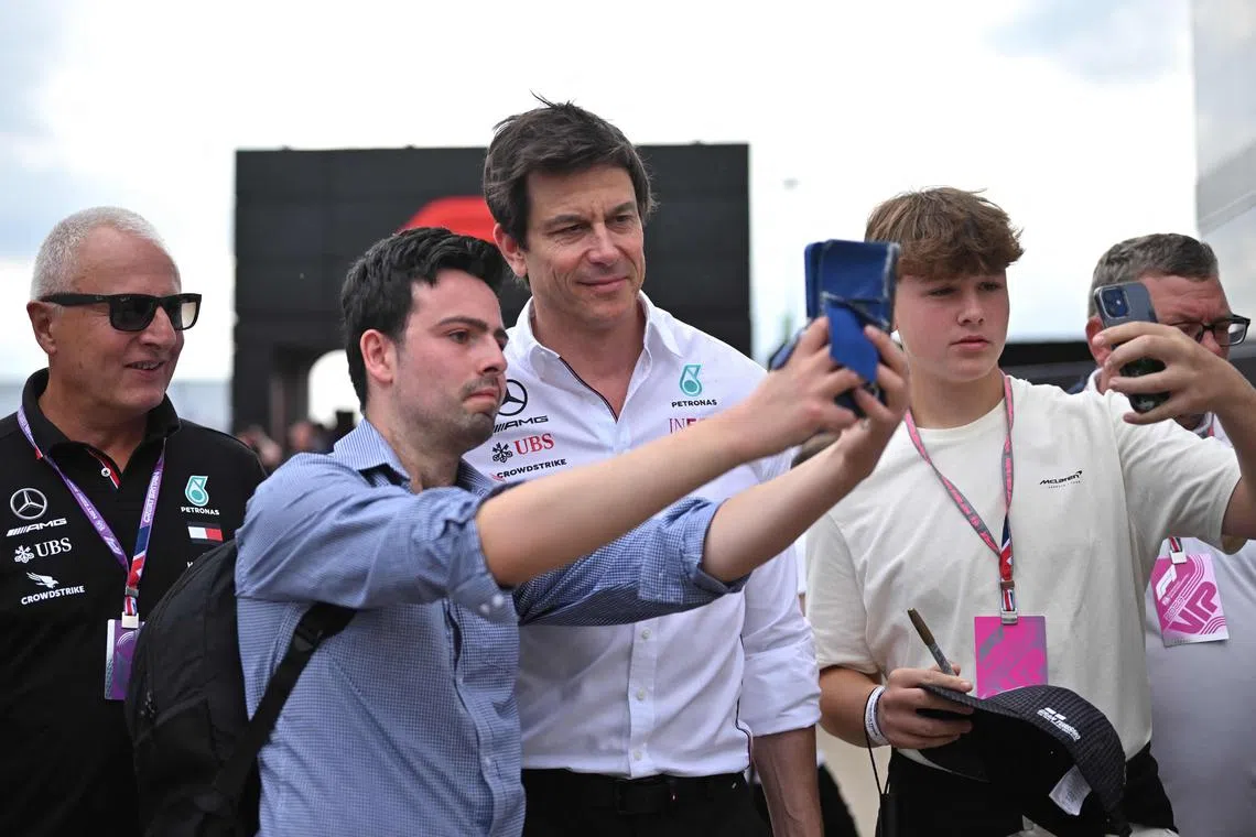 Mercedes F1 team principal Toto Wolff posing for pictures with F1 fans before the third practice session ahead of the Formula One British Grand Prix at the Silverstone. 