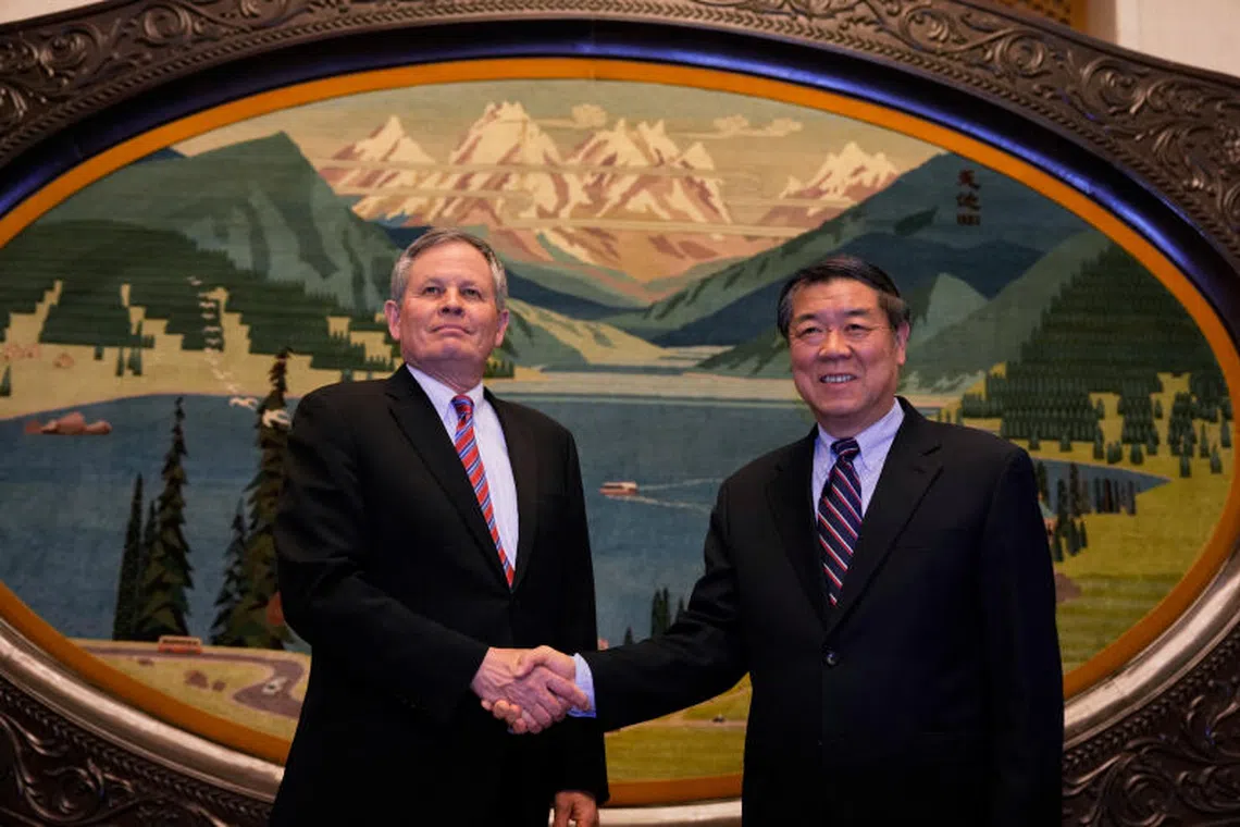 US Senator Steve Daines (left) shakes hands with Chinese Vice Premier He Lifeng before a meeting at the Great Hall of the People on March 22.