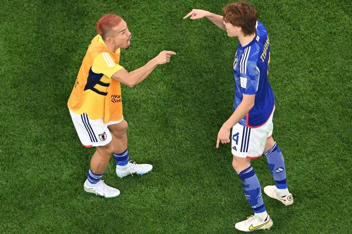 Japan defender Yuto Nagatomo celebrating with Kou Itakura after their World Cup victory over Germany.