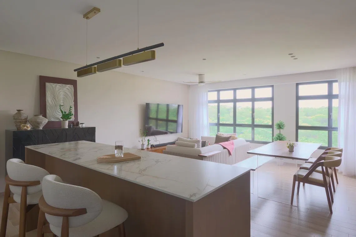 This flat is home to a couple who love to entertain, and this island counter is a key aspect of their gatherings.