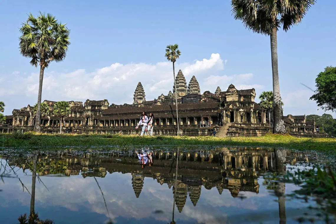 Tourists visit the Angkor Wat temple complex, a UNESCO World Heritage Site, in Siem Reap province on January 16, 2023. (Photo by TANG CHHIN SOTHY / AFP)