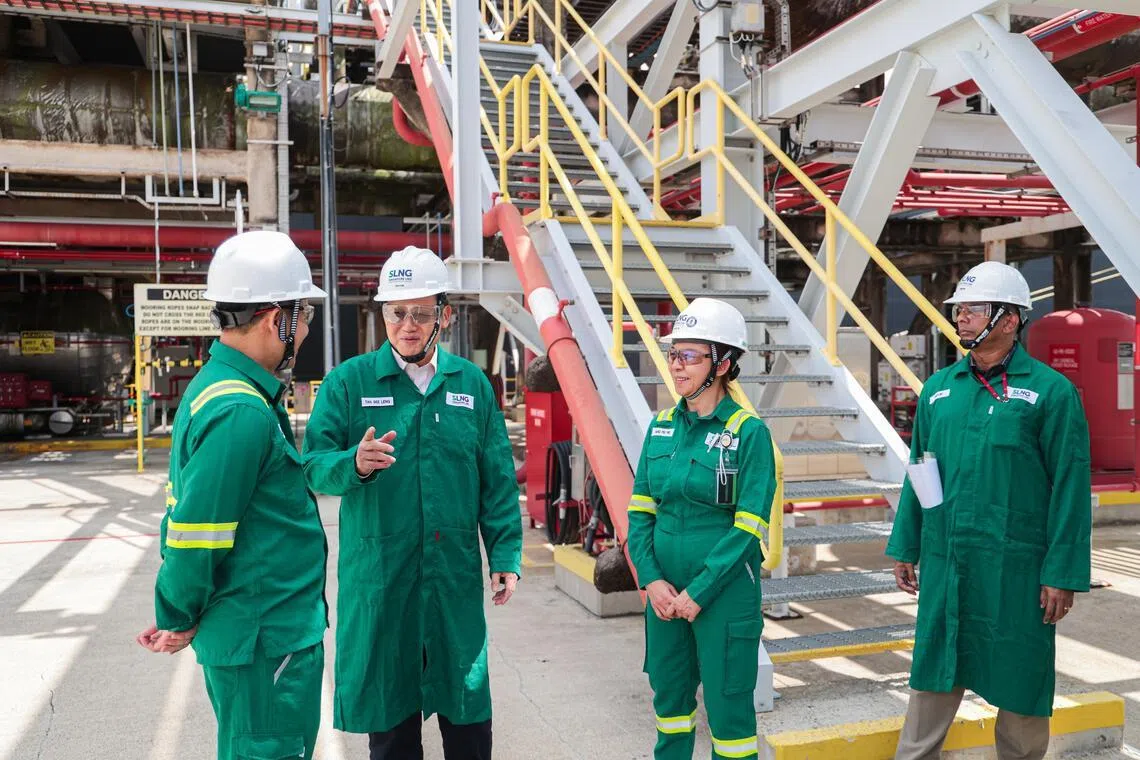 Minister-in-charge of Energy and Science & Technology Tan See Leng (second from left) speaking to workers during a visit to the SLNG Terminal on Jurong Island on March 20.