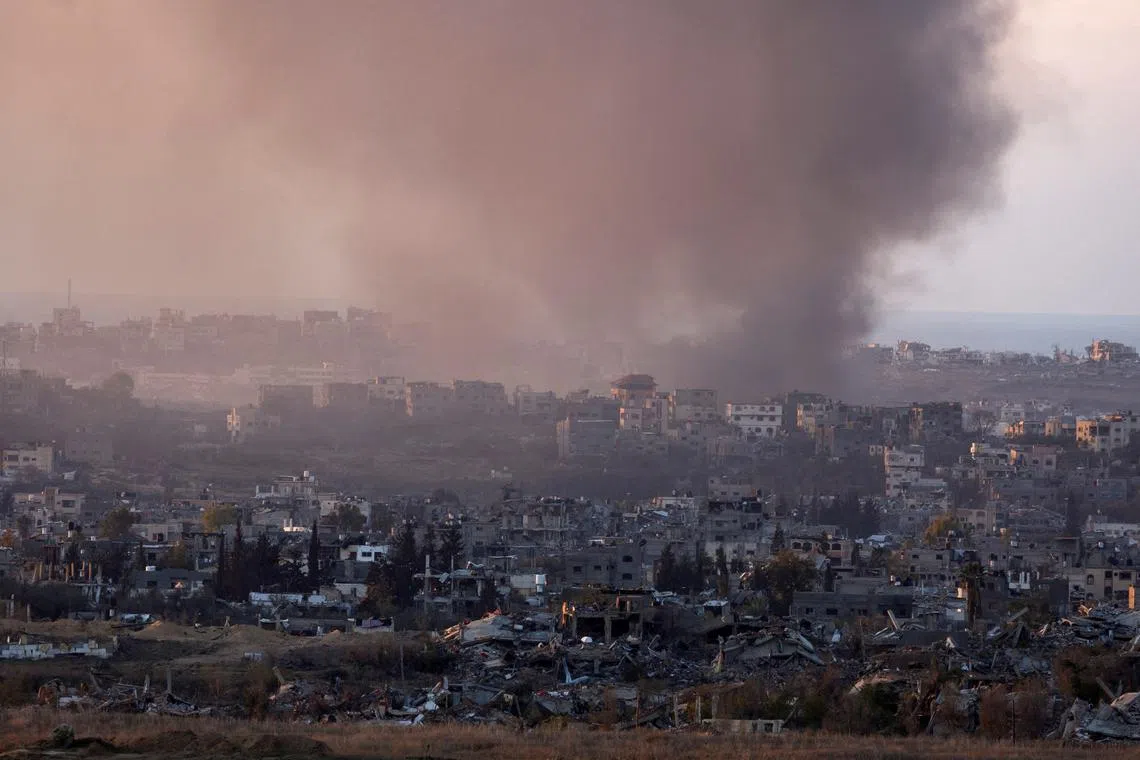 FILE PHOTO: Smoke rises from Gaza, amid the ongoing conflict in Gaza between Israel and Hamas, as seen from the Israeli side of the border, December 16, 2024. REUTERS/Amir Cohen/File Photo