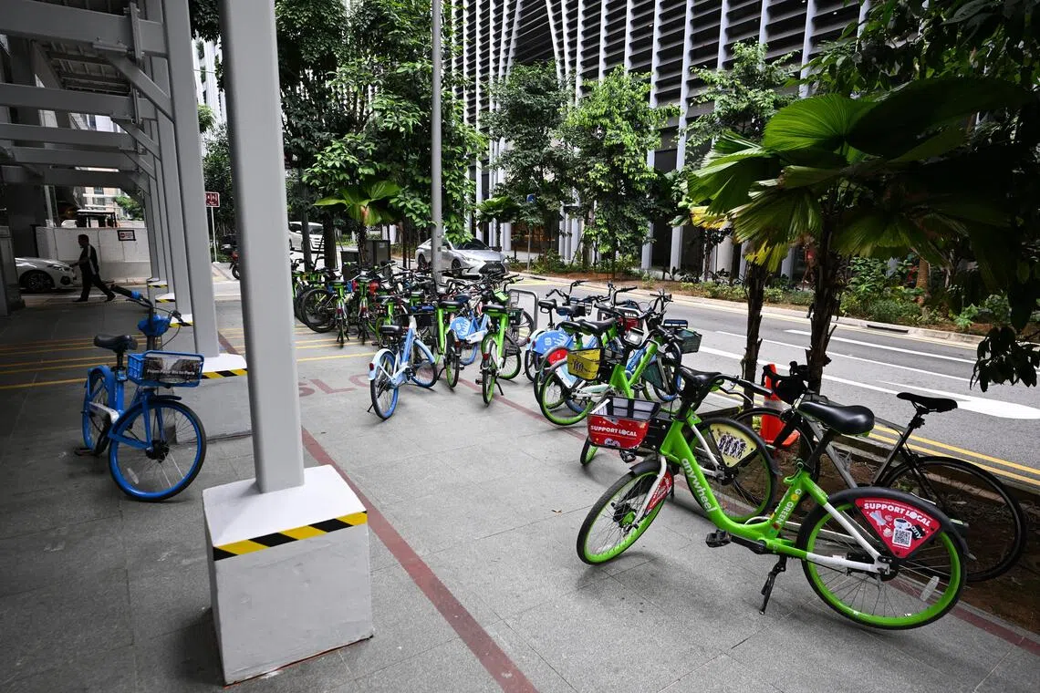 Some HelloRide and AnyWheel bicycles parked outside the demarcated parking zone along Market Street near Bank of Singapore on Sept 17.