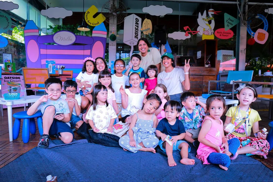 Shanti Pereira with her sisters, Valerie, left, and Shobi, behind her, and a bunch of kids at an event at Cafe Melba at the Goodman Arts Centre. 