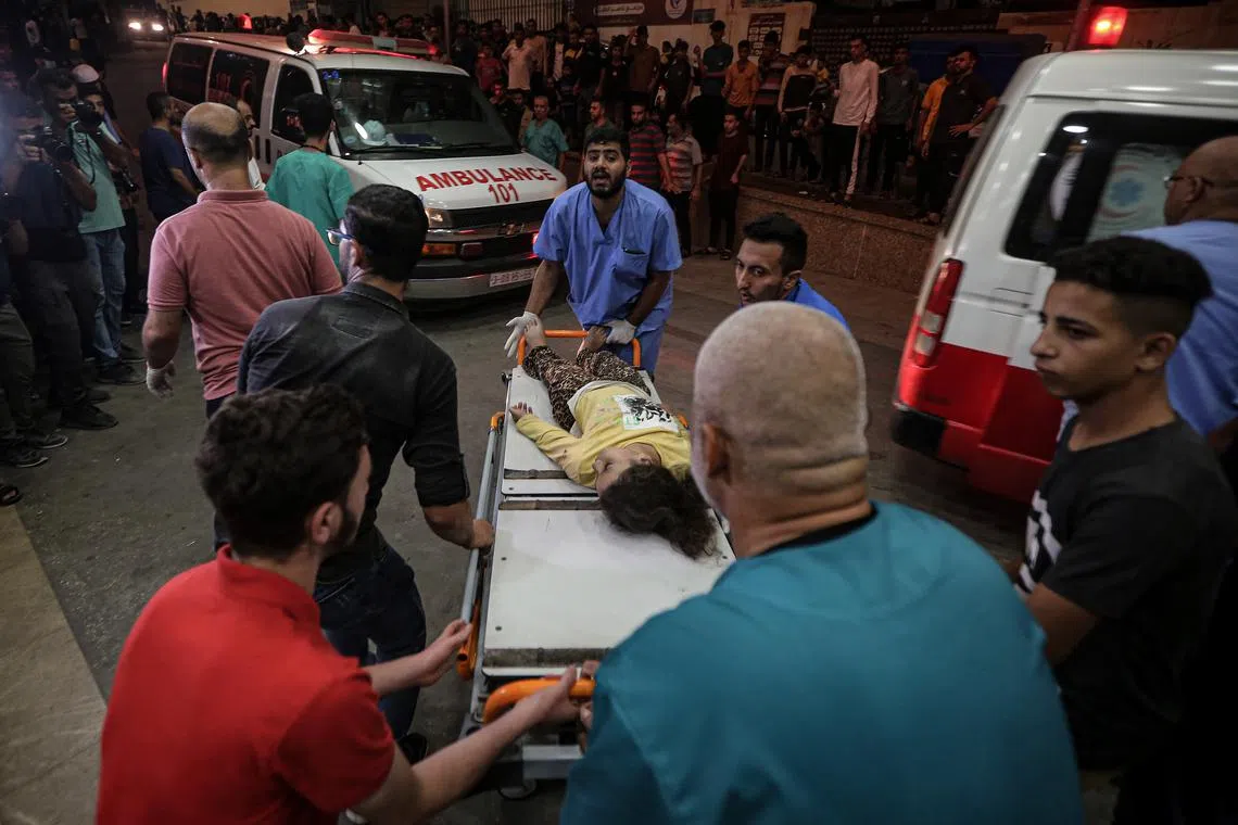 An injured child is rushed into Nasser Medical Hospital in Khan Younis, in southern Gaza, following an Israeli air strike on Oct 25, 2023.