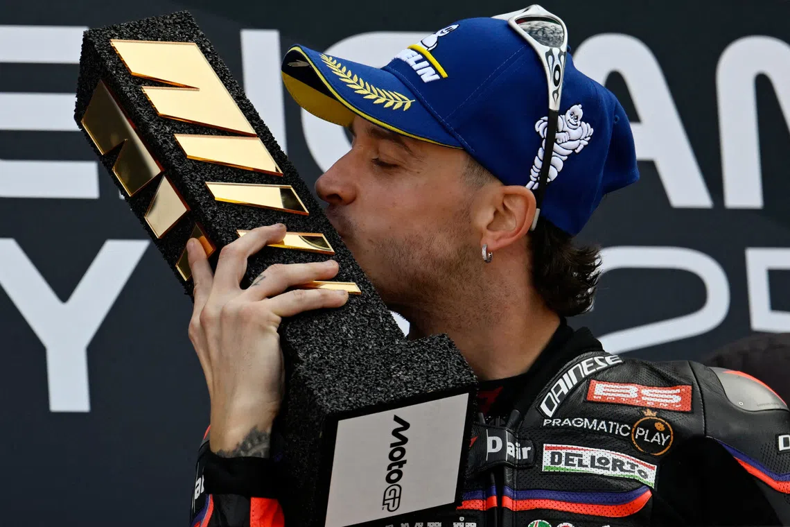 MotoGP - Valencia Grand Prix - Circuit Ricardo Tormo, Valencia, Spain - November 16, 2025 Aprilia Racing's Marco Bezzecchi celebrates on the podium after winning the MotoGp race REUTERS/Pablo Morano