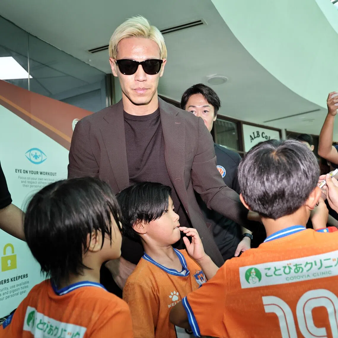 FC Jurong’s new signing Keisuke Honda, 40, signing autographs at his unveiling on Aug 22.