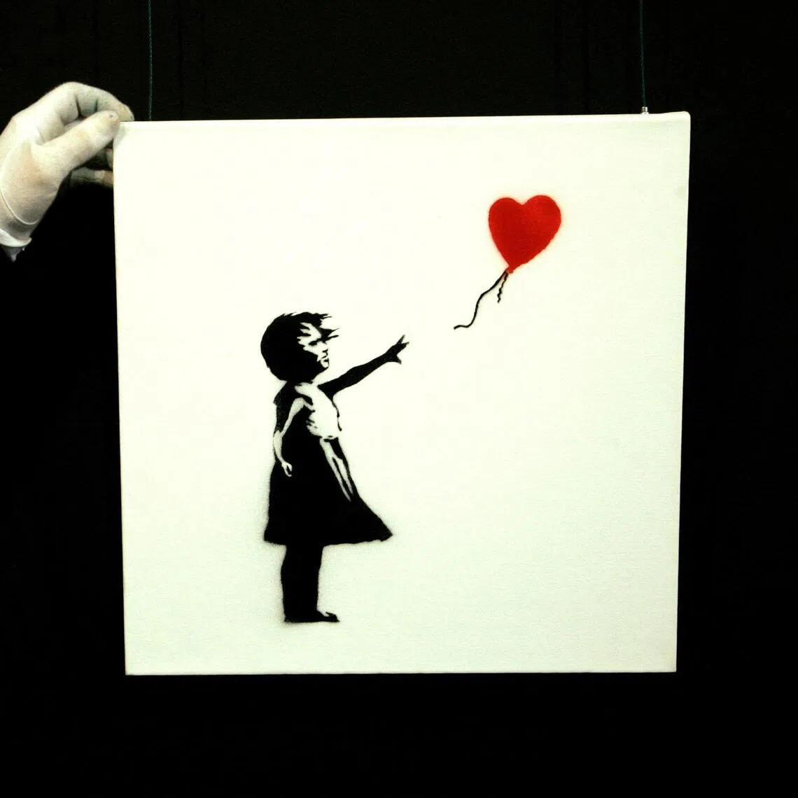 Banksy's artwork Balloon Girl at Sotheby's auction house at Olympia in London on Feb 2, 2007.