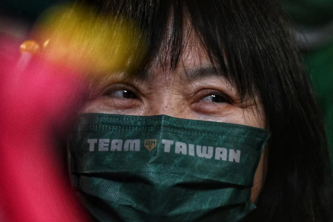 A supporter wearing a mask in support of DPP presidential candidate Lai Ching-te at a rally in Taipei on Jan 11, 2024.