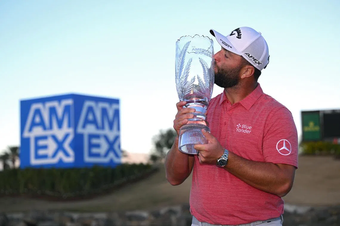 Jon Rahm kisses the winner's trophy after the final round of The American Express golf tournament at Pete Dye Stadium Course.