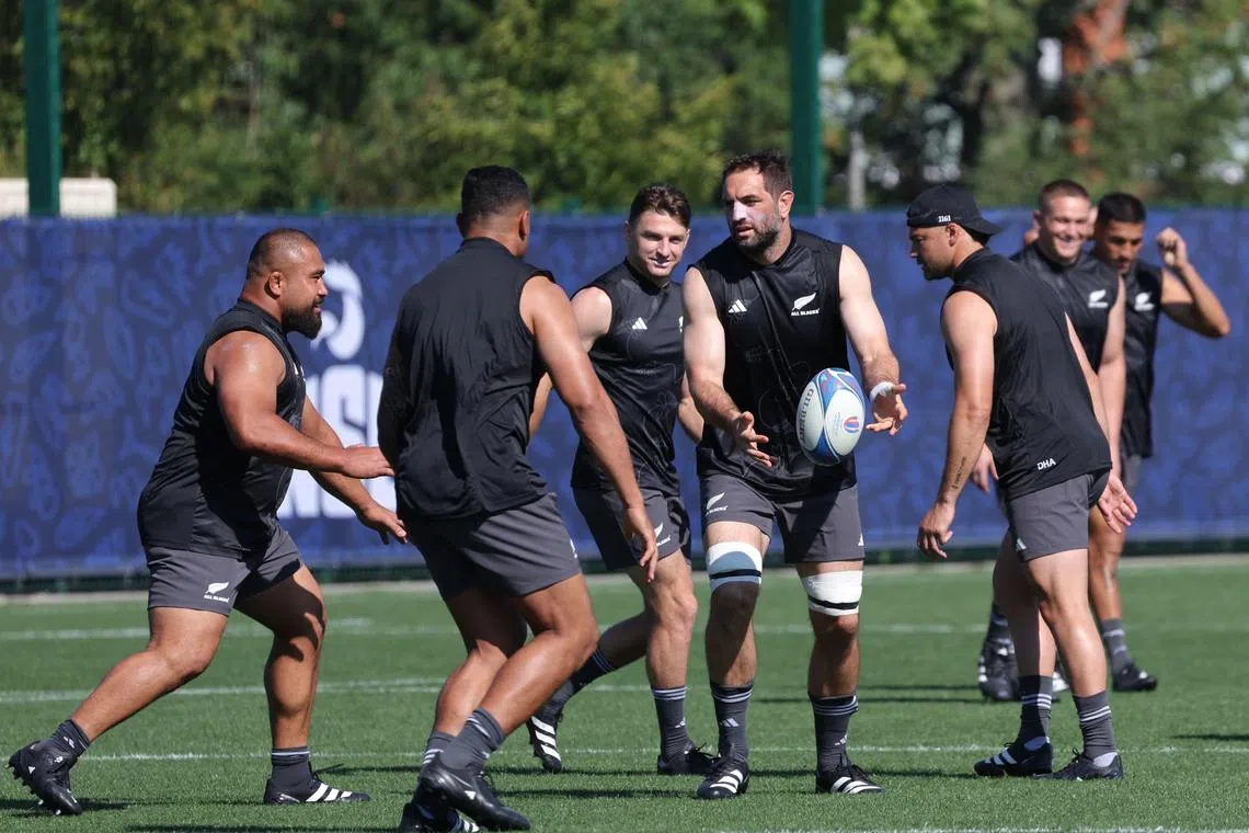 New Zealand lock Samuel Whitelock passing the ball during a training session.