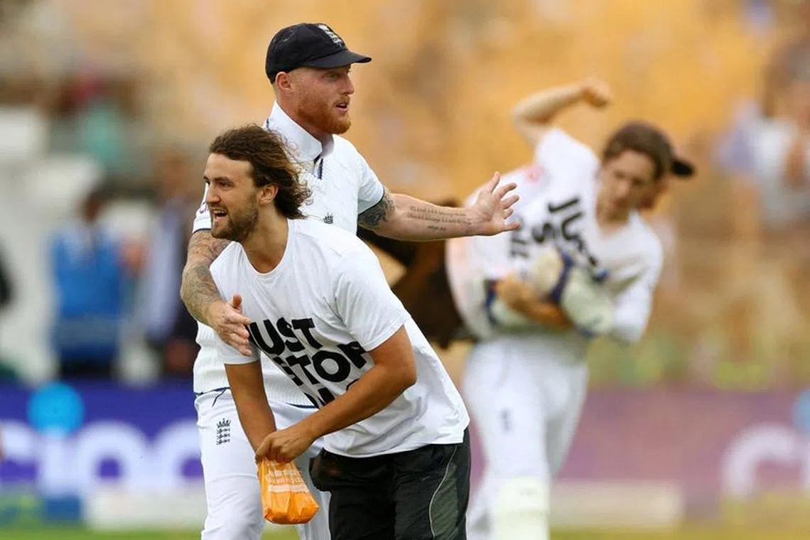 FILE PHOTO: Cricket - Ashes - Second Test - England v Australia - Lord's Cricket Ground, London, Britain - June 28, 2023 England's Ben Stokes tries to stop a just stop oil protester Action Images via Reuters/Matthew Childs/File Photo