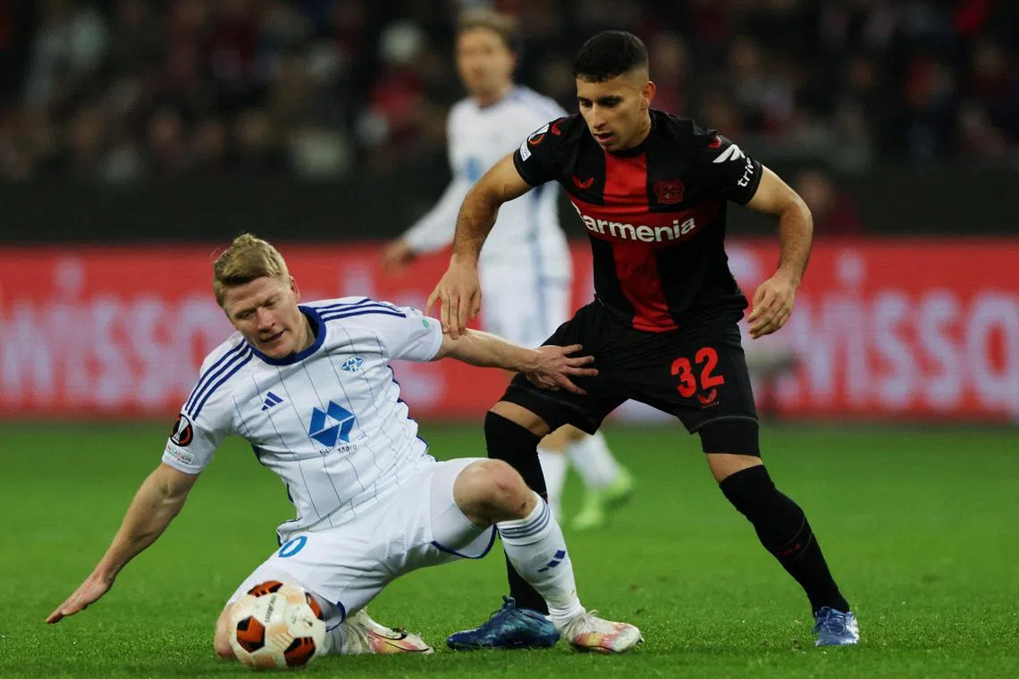 FILE PHOTO: Soccer Football - Europa League - Group H - Bayer Leverkusen v Molde - BayArena, Leverkusen, Germany - December 14, 2023 Molde's Kristian Eriksen in action with Bayer Leverkusen's Gustavo Puerta REUTERS/Thilo Schmuelgen/File Photo
