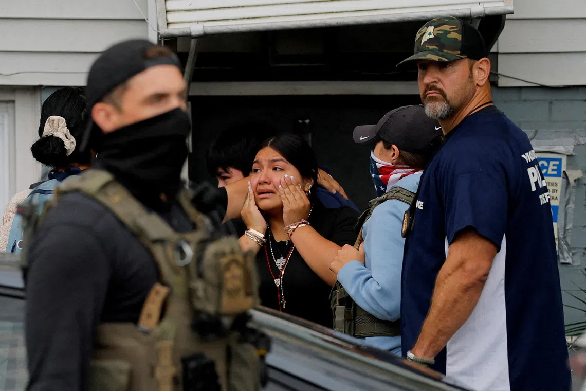 Children react after seeing their mother detained during an immigration enforcement raid in Chelsea, Massachusetts, U.S., September 26, 2025. Their mother was released at the scene because she is reportedly a legal U.S. resident and she was taken to the hospital for evaluation.   REUTERS/Brian Snyder